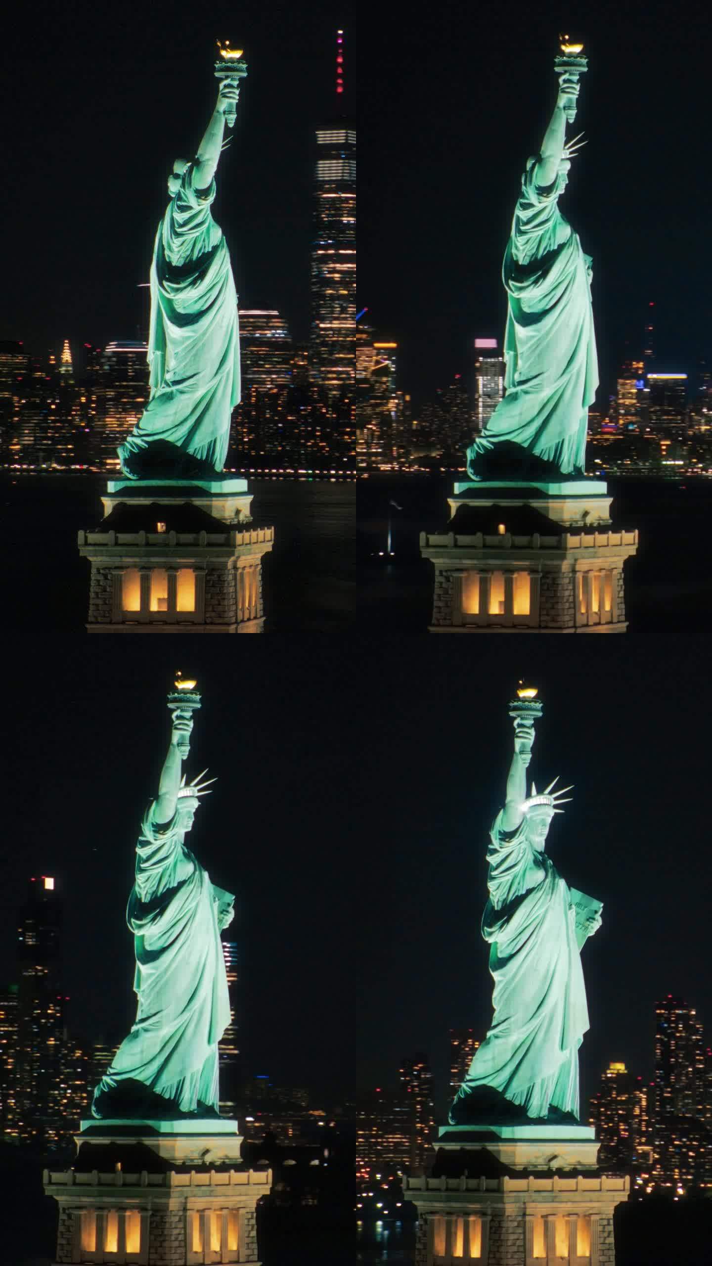 垂直屏幕:美国自由象征的全景航拍镜头。电影直升机在夜晚经过自由女神像。地标性的纽约纪念碑和曼哈顿摩天