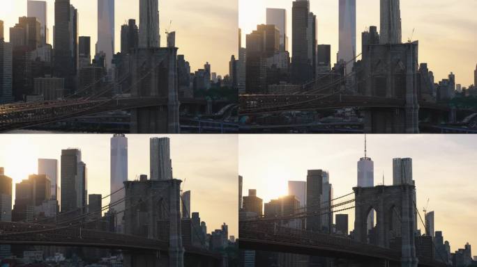 布鲁克林大桥附近的空中电影无人机场景与曼哈顿下城摩天大楼的城市景观。美丽的晚霞闪耀着温暖的晚霞。悬索
