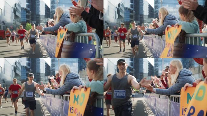 一名男性马拉松运动员在跑步时与观众中的女性家庭成员击掌的慢动作肖像。中年妻子支持丈夫参加慈善城市马拉