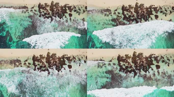 慢镜头拍摄俯视海水拍打礁石