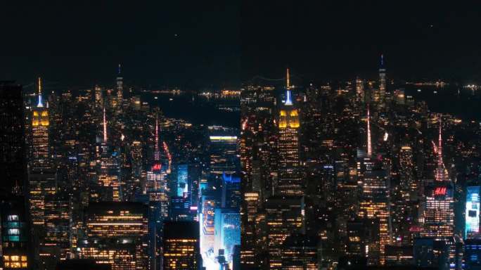垂直屏幕:晚上的纽约混凝土丛林。直升机之旅的航拍画面。娱乐区和时代广场周围的现代摩天大楼