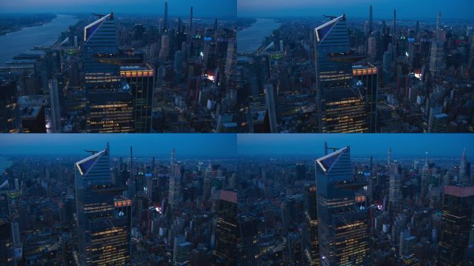 傍晚直升机在曼哈顿天际线上的镜头，聚焦于30哈德逊广场摩天大楼的外部观景台。一群游客在观景台上欣赏城