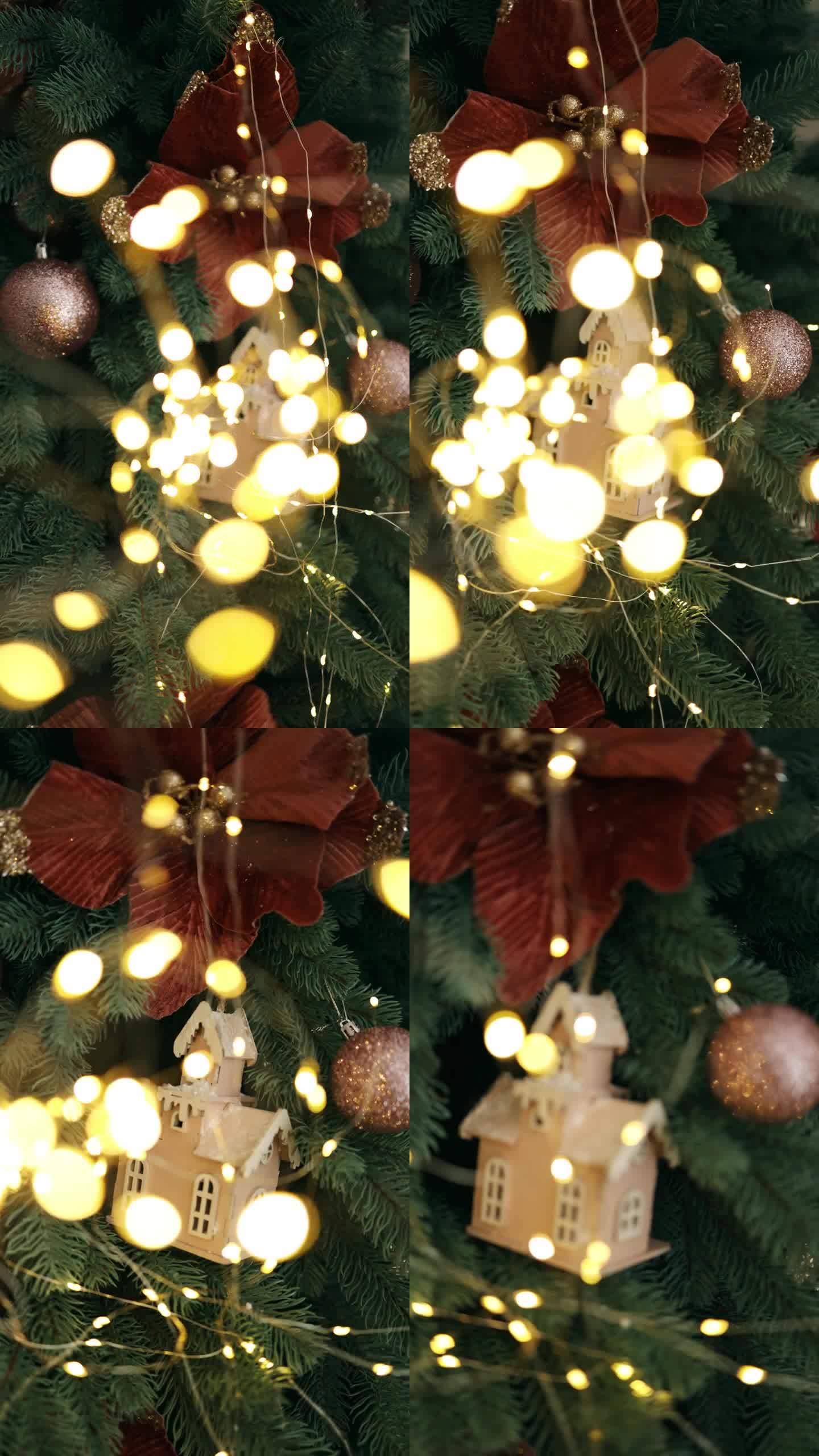 焦点通过灯泡转移到圣诞树上带玩具的花环上。圣诞树上的玩具木屋模型。垂直视频。这棵圣诞树太棒了