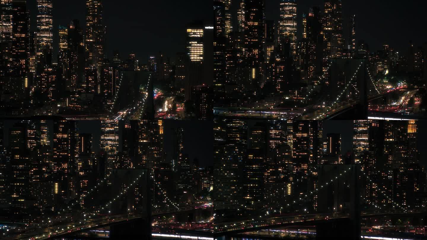 夜间从直升机上拍摄的纽约市天际线航拍画面。著名的摩天大楼和布鲁克林大桥上的美国国旗。繁忙多样的大都市