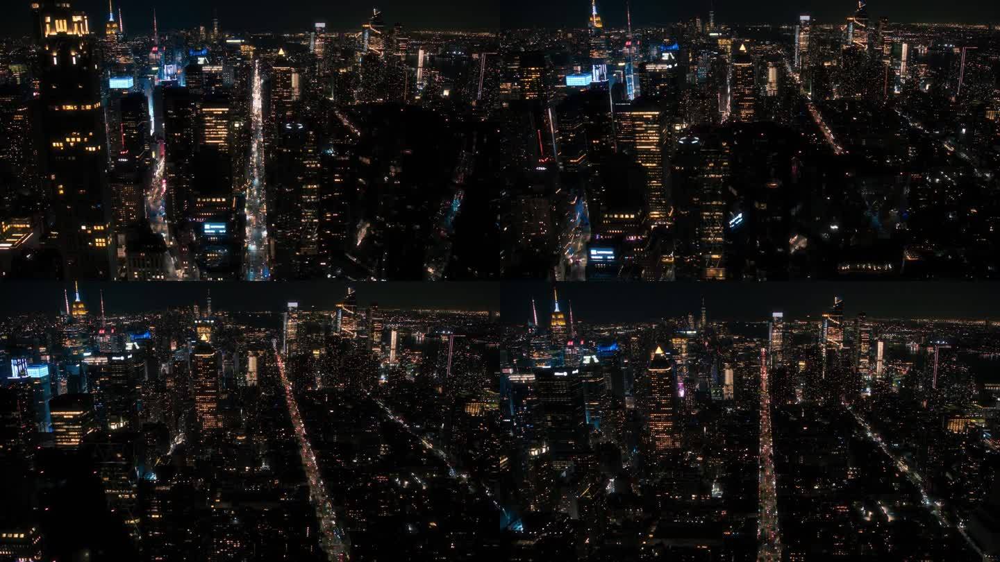 直升机夜游纽约市建筑。飞越曼哈顿，俯瞰灯火通明的办公楼和挤满汽车和出租车的拥挤街道