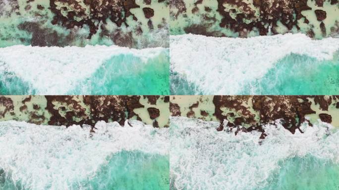 慢镜头俯视海水拍打着沙滩礁石