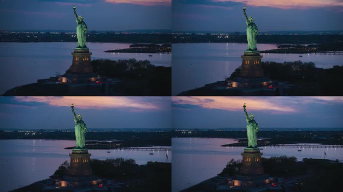 自由女神像周围的空中飞行。直升机拍摄的爱国纪念碑在美丽的日落背景下，站在纽约市港口的自由岛上