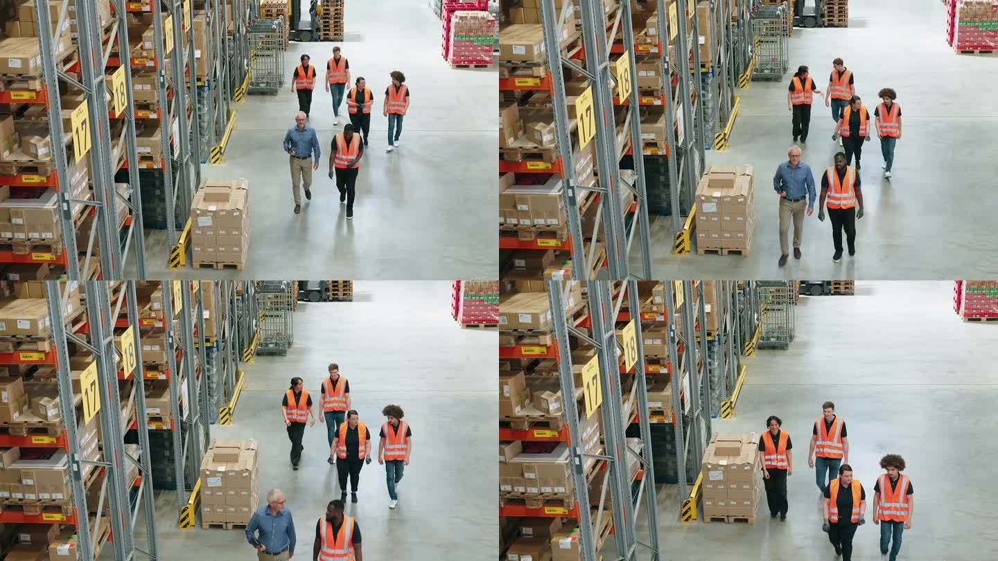 仓库经理和工人在工厂行走的高角度视图