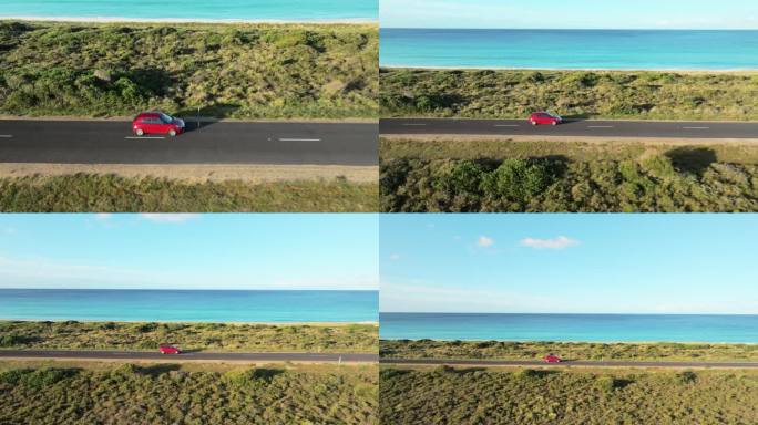 鸟瞰沿着海滩行驶的红色汽车