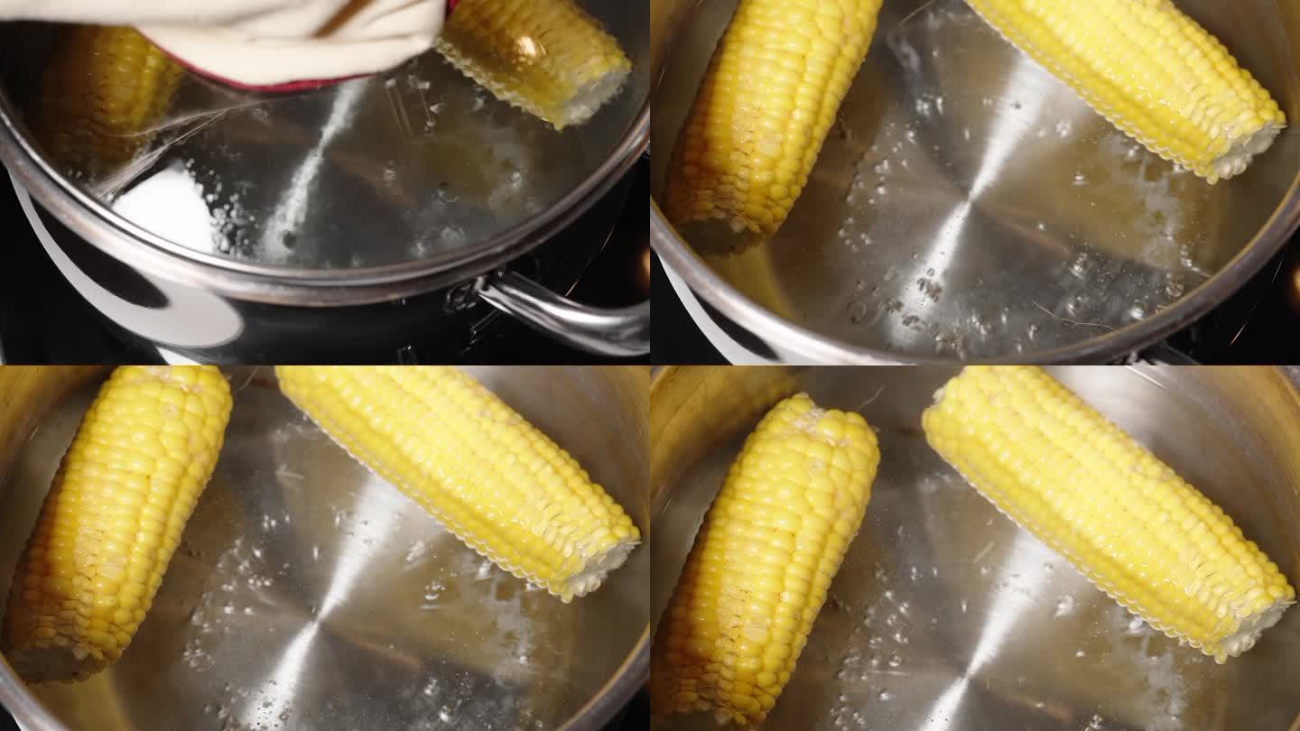 当我打开锅盖时，两个煮熟的玉米棒正在锅里煨着。摄影机以移动摄影机的方式移动。