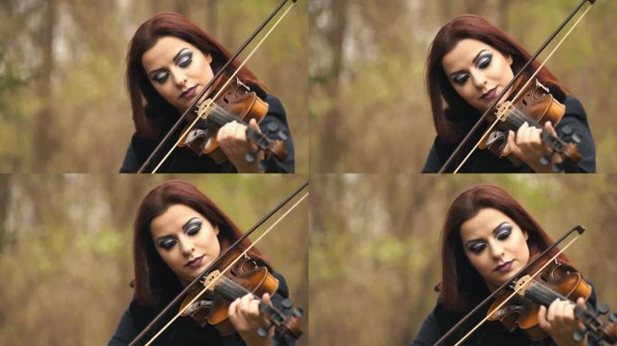 年轻女子在森林里拉小提琴