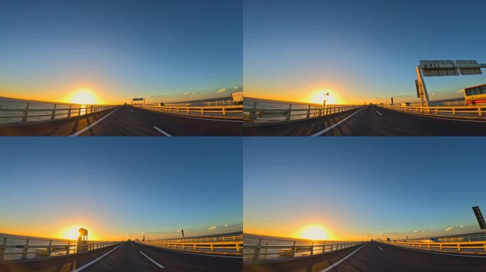 夕阳下行驶在海上高速公路上的汽车