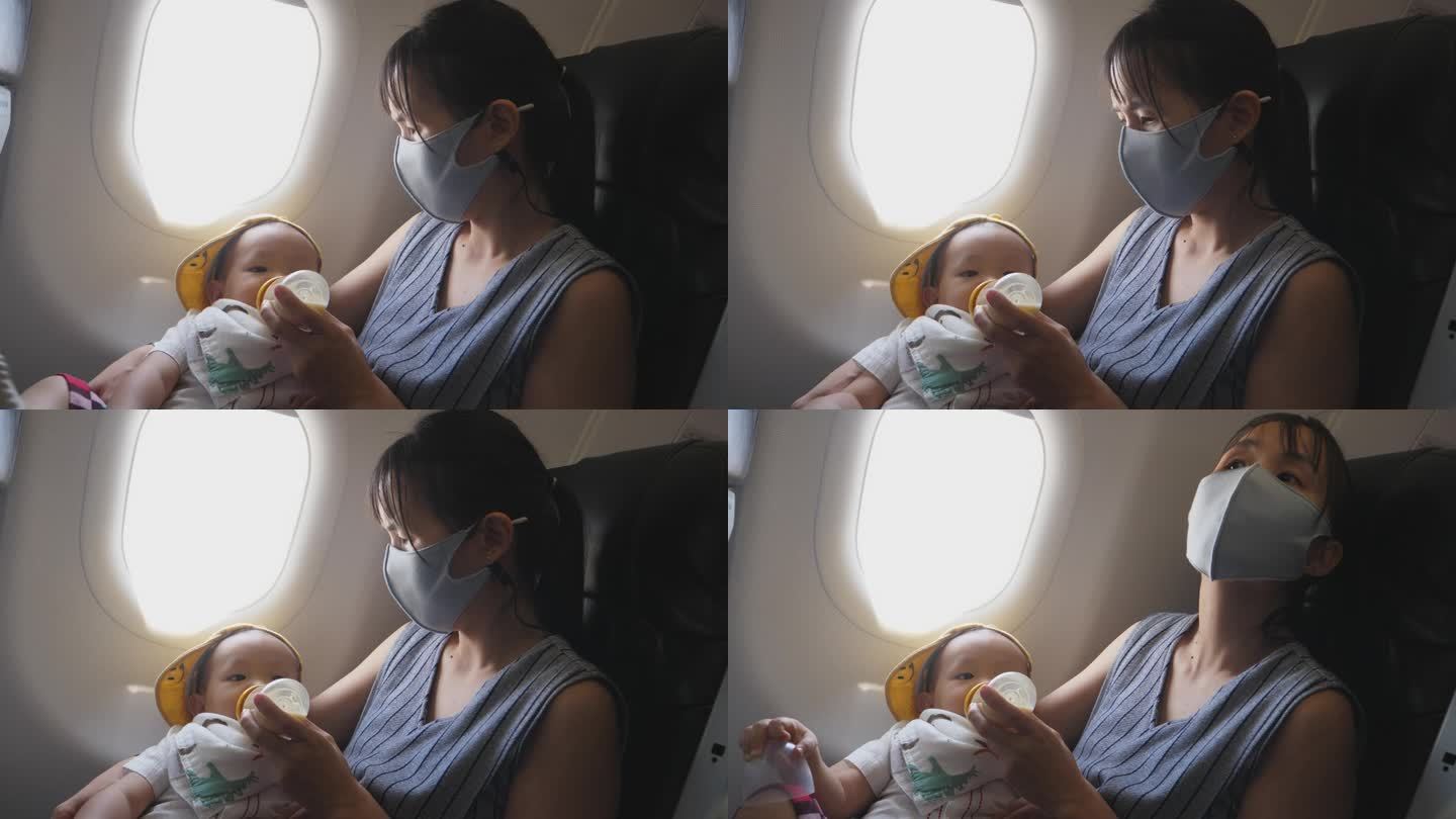 空中餐饮:亚洲母亲在高空探险期间喂蹒跚学步的儿子。