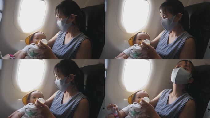 空中餐饮:亚洲母亲在高空探险期间喂蹒跚学步的儿子。