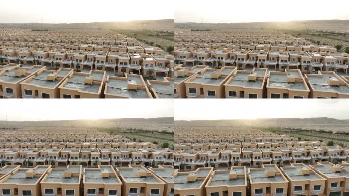 低角度无人机拍摄的巴基斯坦一大片土地上新建的住房社会。房屋协会构想