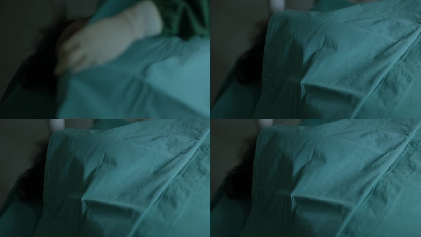 一个手术失败后躺在医院病床上的病人的尸体，医生用绿色的床单盖住他的身体，悲伤地站在他身边的护士。