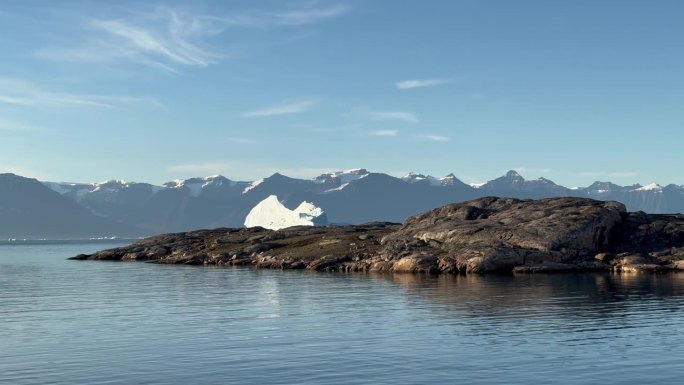 从格陵兰斯科斯比松德丹麦岛上看到的海湾静态景观和孤独的冰山。