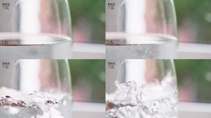水在玻璃水壶里沸腾到100摄氏度，特写。