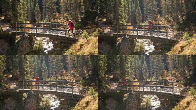 一个女人正穿过山涧上的木桥