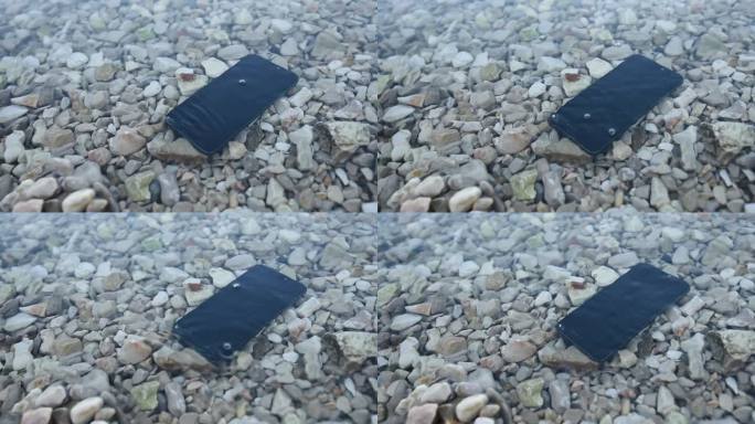 丢失和损坏的手机淹没在海水中
