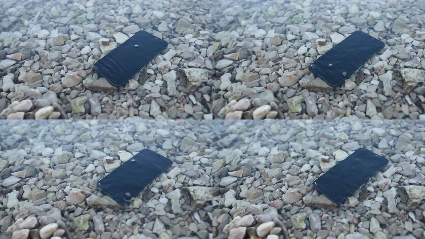 丢失和损坏的手机淹没在海水中