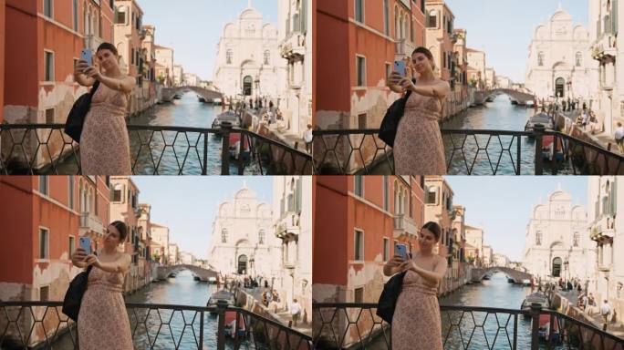 暑假期间，一名年轻女子在威尼斯运河上的一座桥上微笑自拍