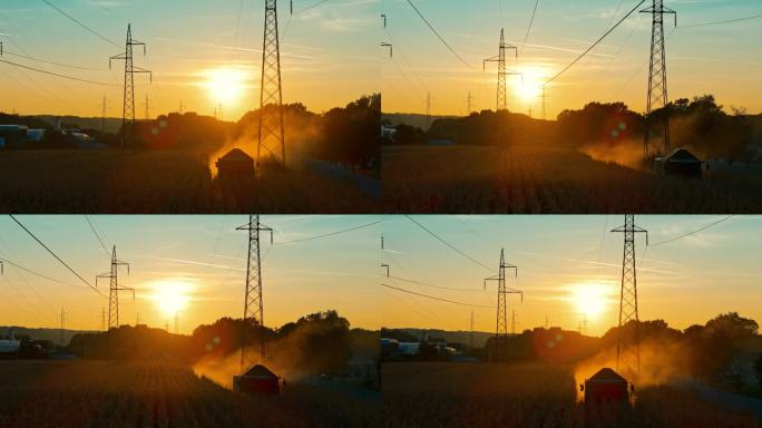 夕阳下的橙色天空下，无人机拍摄的玉米作物生长在田地和电力塔上