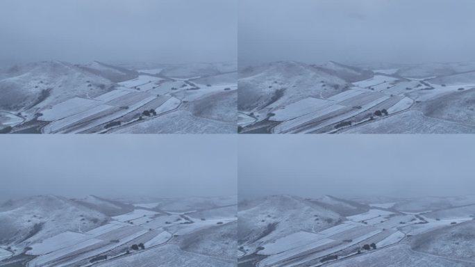 航拍风雪交加的山脉田野