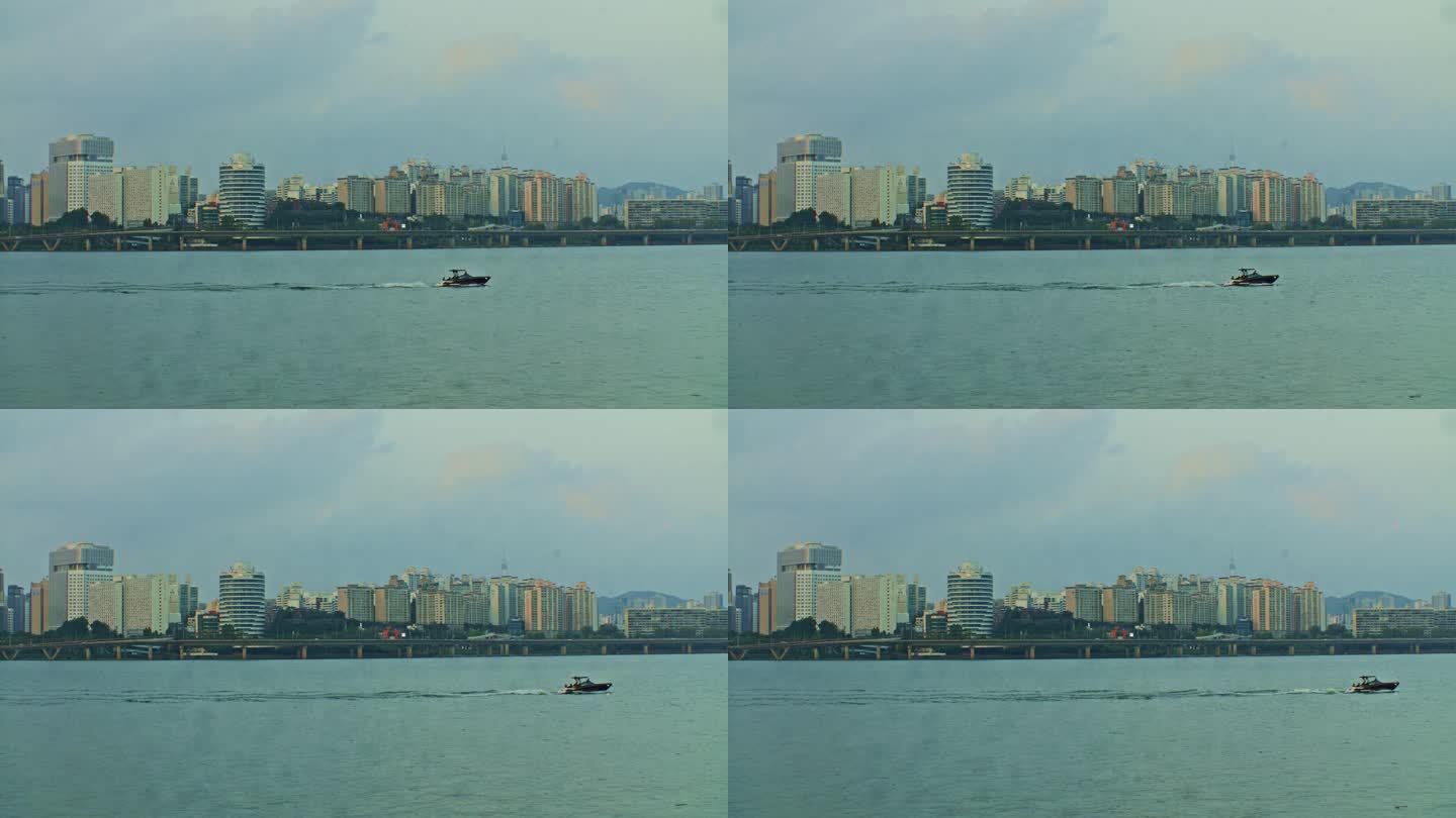 首尔市江边市区公园，傍晚有船，有建筑物和摩天大楼，广角观景，有水，有浪，有天