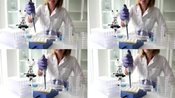 科学家在实验室用移液管分析液体提取DNA和分子