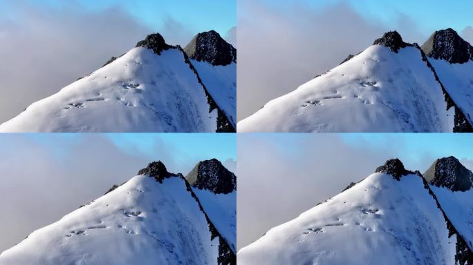 航拍川西贡嘎山区乌库楚雪山山脊上的登山者