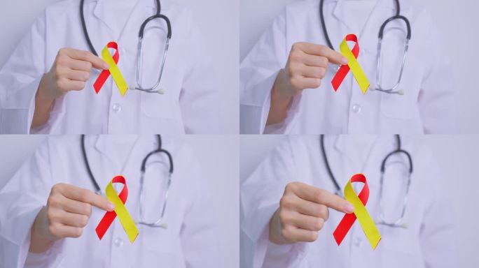 医生拿着红黄丝带。世界肝炎日宣传月，7月28日，肝癌，黄疸，肝硬化，衰竭，扩大，肝性脑病和健康概念