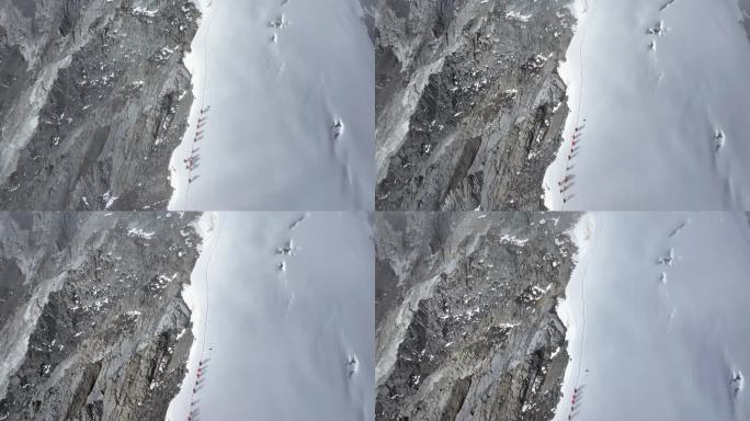 航拍攀登贡嘎山卫峰乌库楚雪山上的登山者