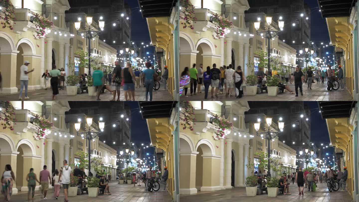 多米尼加共和国，圣多明各——2023年7月17日:夜晚，人们在路灯的照耀下走过殖民城的Calle E