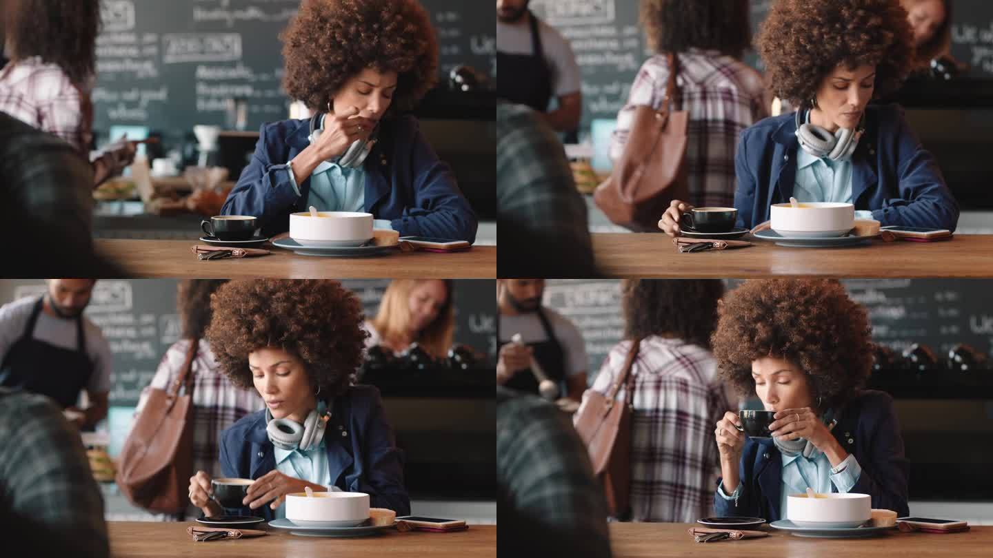 漂亮的卷发女人在咖啡馆用智能手机喝咖啡发短信在社交媒体上分享信息在繁忙的餐厅享受移动技术
