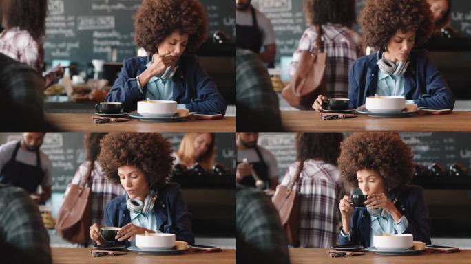 漂亮的卷发女人在咖啡馆用智能手机喝咖啡发短信在社交媒体上分享信息在繁忙的餐厅享受移动技术