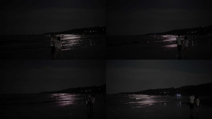 月光下海边散步的情侣