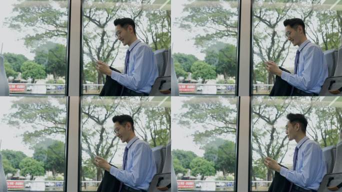 一名亚洲男子在上班途中使用手机。
