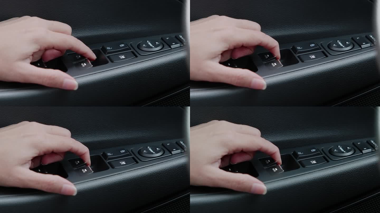 女性的手打开车门上的车窗控制按钮。