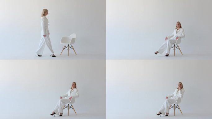 漂亮的女人坐在椅子上，在白色背景下进行眼神交流