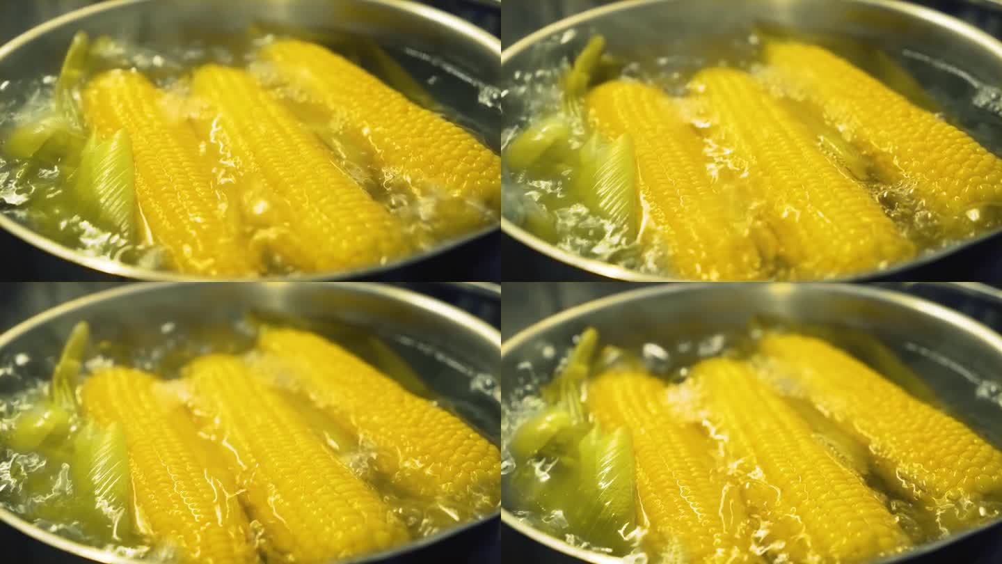 在厨房的锅里用热水煮甜玉米棒