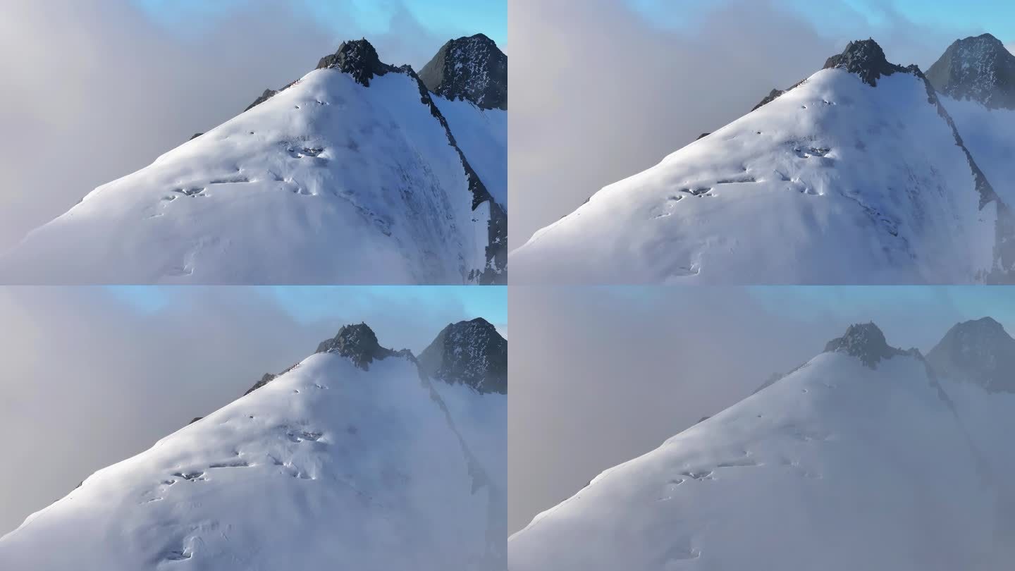 航拍川西贡嘎山区乌库楚雪山山脊上的登山者