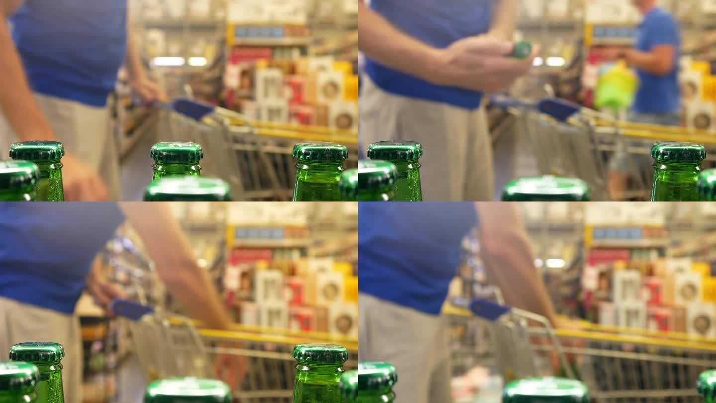 酒类部许多绿色玻璃瓶的啤酒，一个推着购物车的男人拿了一瓶
