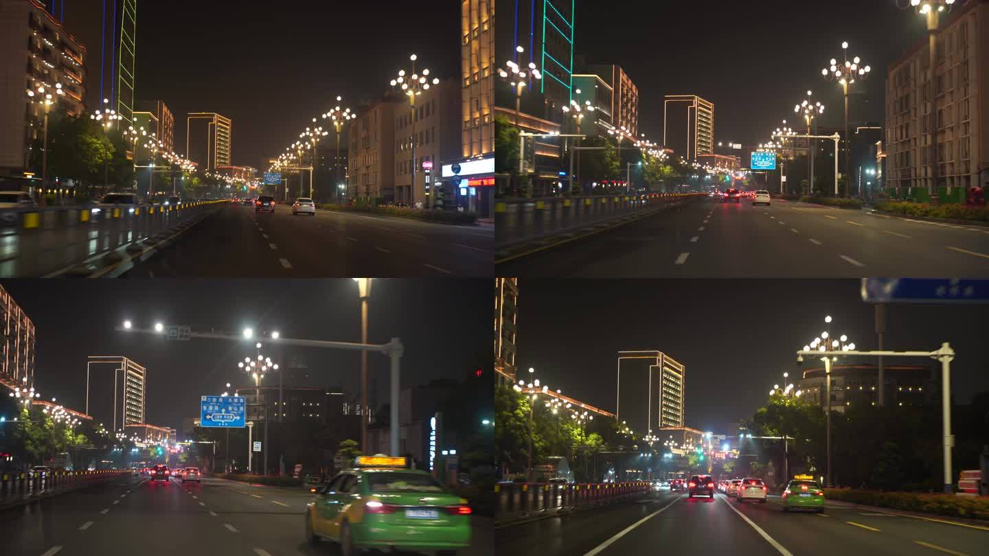 夜间开车行驶在城市道路夜晚城市车窗外风景