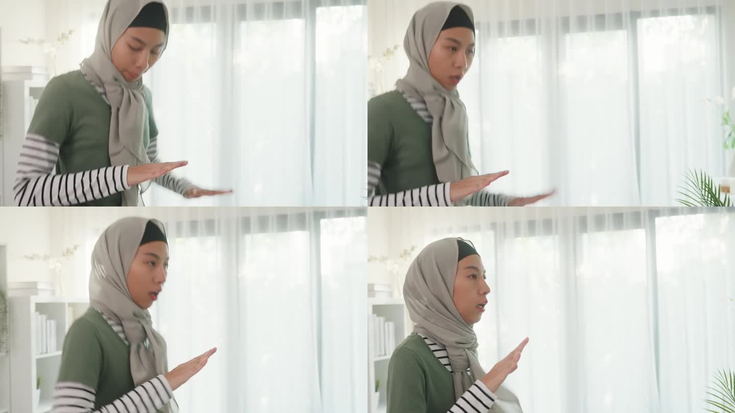 特写运动亚洲伊斯兰妇女的脸穿穆斯林运动服锻炼身体锻炼高膝盖初学者练习在线课程训练在家里的客厅。保健和