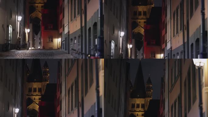 科隆夜景与石头狭窄的人行道小巷和教堂在科隆老城，德国，电影拍摄