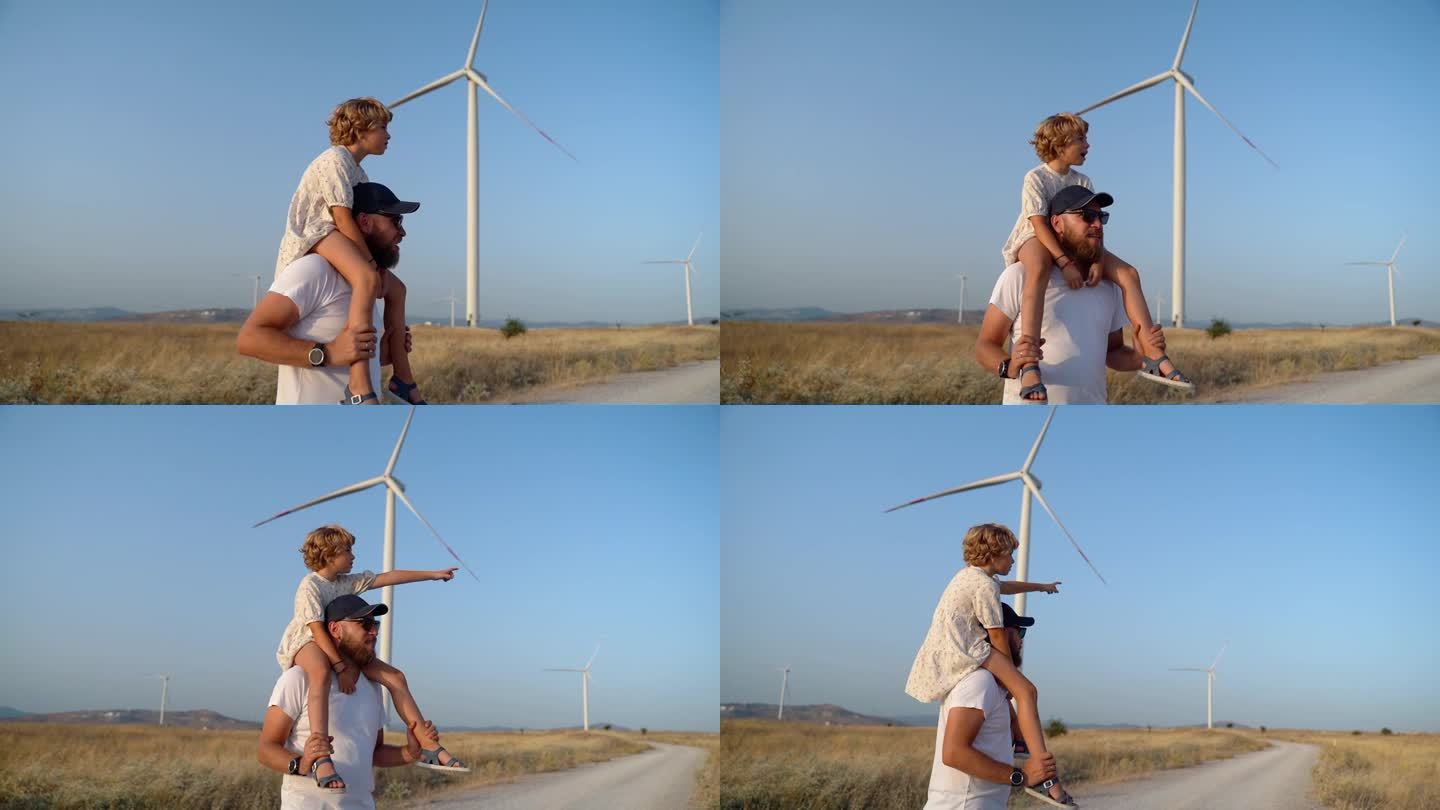 一个男人背着他的小女孩走在风电场里。快乐父女共度美好时光，共享清新空气，共创更环保、可持续、高效的能