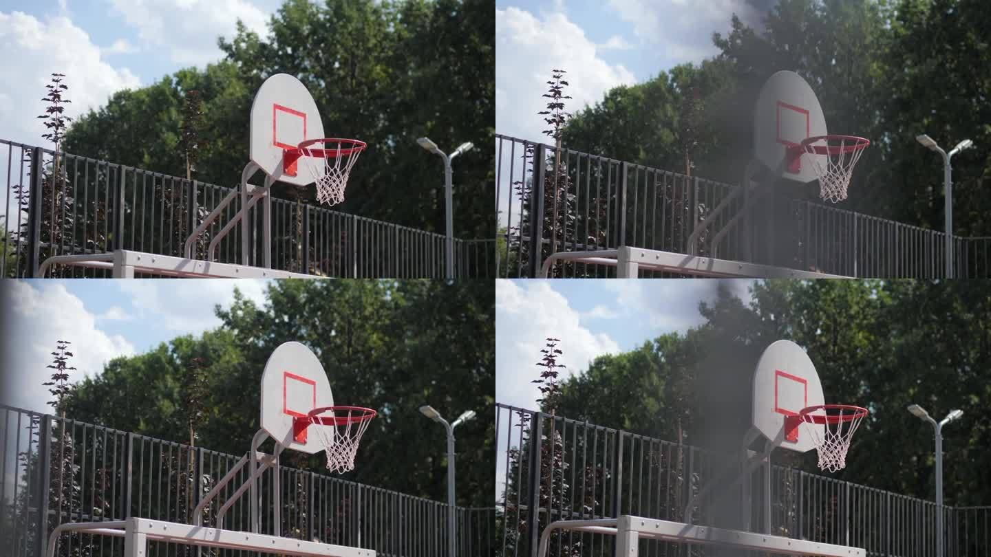 公园篮球运动场上的带篮圈和网的盾牌