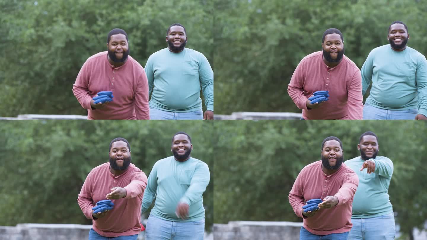 两个魁梧的黑人在公园里玩掷豆袋游戏