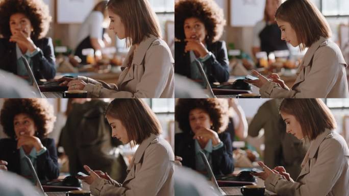 年轻女子用笔记本电脑在咖啡馆工作，在智能手机上打字，在社交媒体上分享信息，享受坐在繁忙的餐厅里